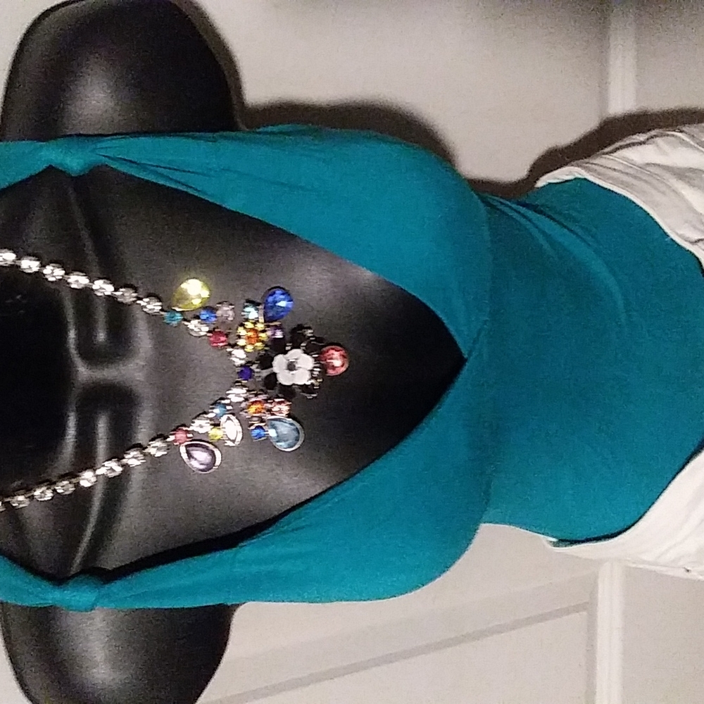 A deep turquoise green sexy bohemian top .